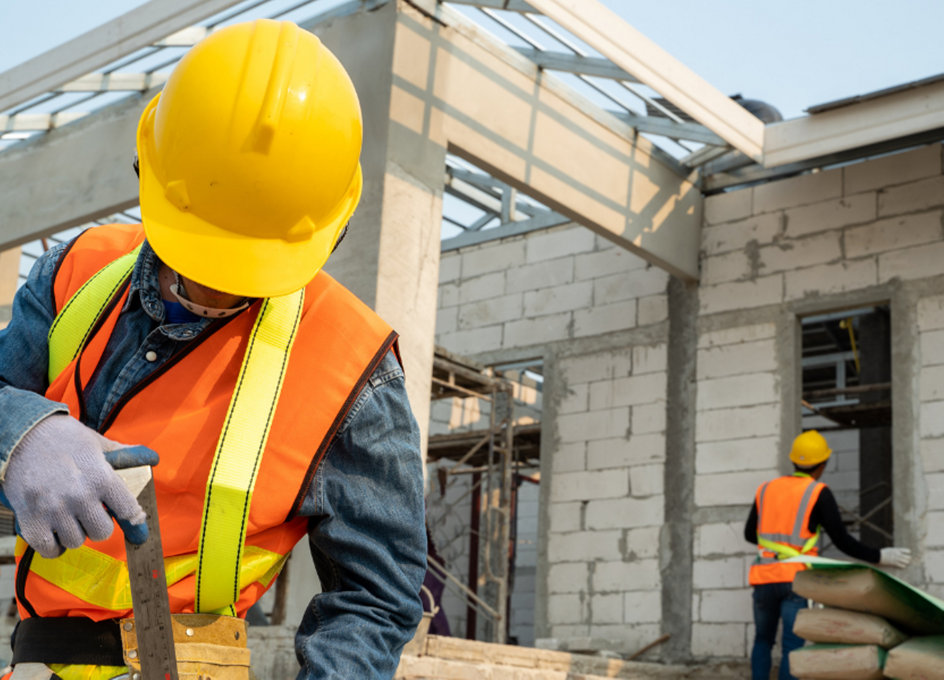 workers installing window on construction site